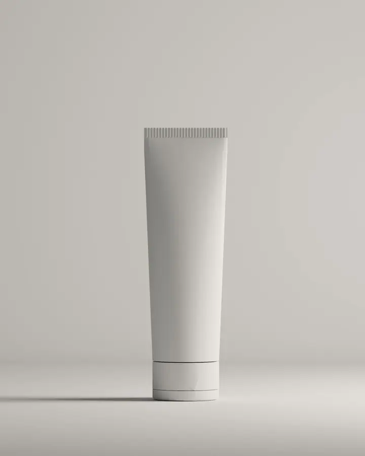 Upright white matte cosmetic tube on a soft grey studio floor